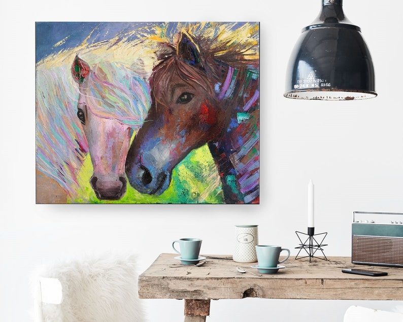 May include: A painting of two horses, one white with a pink nose and the other brown with a colorful mane, looking at each other.