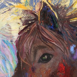 May include: Close-up of a painting of a horse's eye. The eye is brown with a green iris and black pupil. The horse's fur is brown and the background is a mix of blue, yellow, and purple.