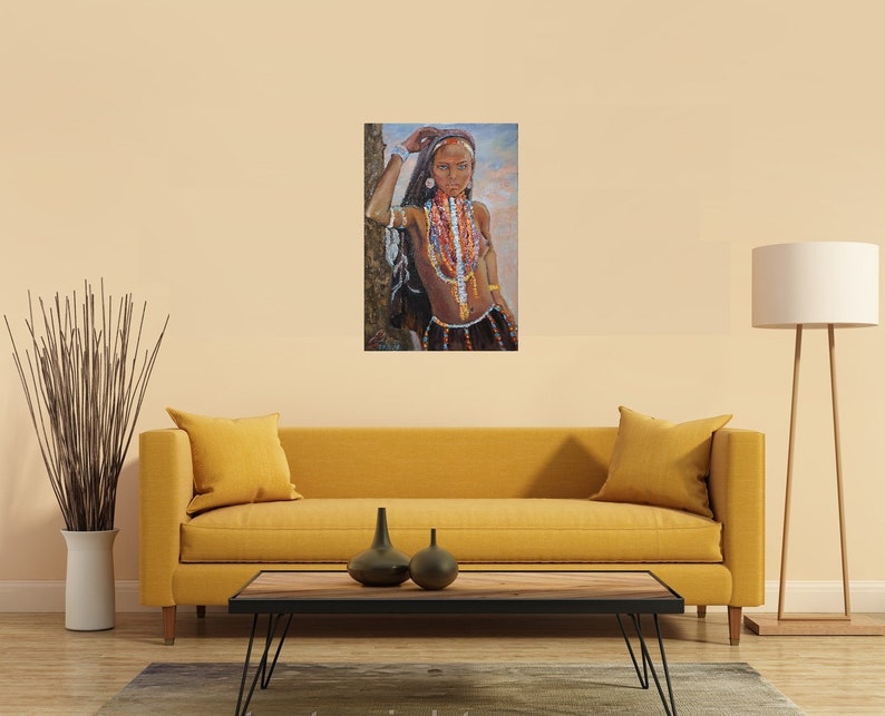 May include: A painting of a woman with dark hair and brown skin wearing a colorful beaded necklace and a red head scarf. She is standing in front of a tree and looking directly at the viewer.