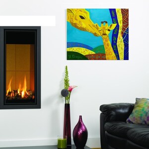 May include: A colorful painting of two giraffes, a mother and her baby, with a blue background and yellow, green, and red accents. The painting is framed and hanging on a white wall.