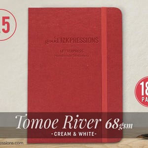 May include: A red A5 notebook with a vertical elastic closure. The cover features the embossed text good INKPRESSIONS LETTERPRESS Handmade Stationery. Additional text indicates 180 PAGES and Tomoe River 68gsm - CREAM & WHITE -.