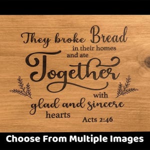 May include: A rectangular wooden serving tray with black handles. The tray features the engraved text "They broke Bread in their homes and ate Together with glad and sincere hearts Acts 2:46".