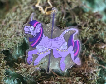 May include: A purple and pink cartoon pony with a golden star on top of its head. The pony is wearing a white and purple dress with gold stars and pearls. The pony is a carousel horse.