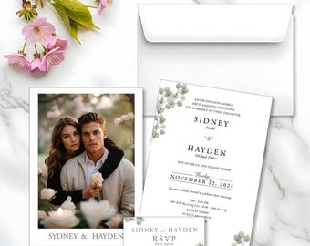 May include: Wedding invitation suite featuring a photo card, invitation, RSVP card, and envelope. The invitation includes the names "Sidney" and "Hayden" and the date "November 22, 2024". The suite is decorated with eucalyptus sprigs and pink flowers.