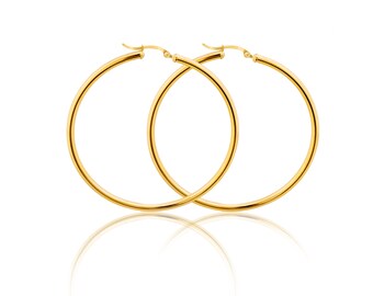 May include: A pair of gold hoop earrings. The earrings are simple and elegant, with a smooth, polished finish.