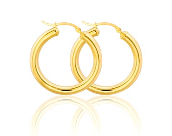 May include: A pair of gold hoop earrings. The earrings are simple and classic, with a smooth, polished finish.