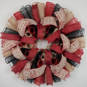 May include: A red, black, and beige wreath with a fire fighter theme. The wreath is decorated with ribbons that say "Brave", "Firefighter", "Hero", "Search & Rescue", "Thank you", "Proud", "Love", "Strong", and "Five Alarm".