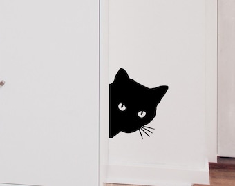 May include: A black cat silhouette peeking around a white cabinet door, with a golden retriever dog looking out a white door behind it.
