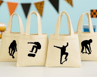 May include: Four cream-colored tote bags with black skateboarder silhouettes. Each bag has a rectangular shape with a handle. The background includes orange, black, and white decorative banners, and a light blue backdrop.