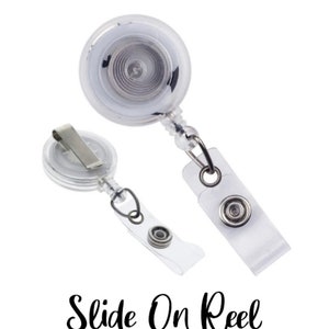 May include: Two clear plastic retractable badge reels with a metal clip and a snap closure. The reels have a silver-colored metal center and a clear plastic strap. The text "Slide On Reel" is written in black script.