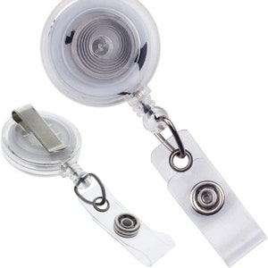 May include: Two clear plastic retractable badge holders with a silver clip and a slide-on reel. The text "Slide on Reel" is written below the holders.