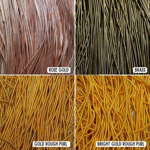 May include: Close-up of four different types of wire. Rose gold, brass, gold rough purl, and bright gold rough purl are displayed. The wires are thin and flexible, ideal for jewelry making and crafting.