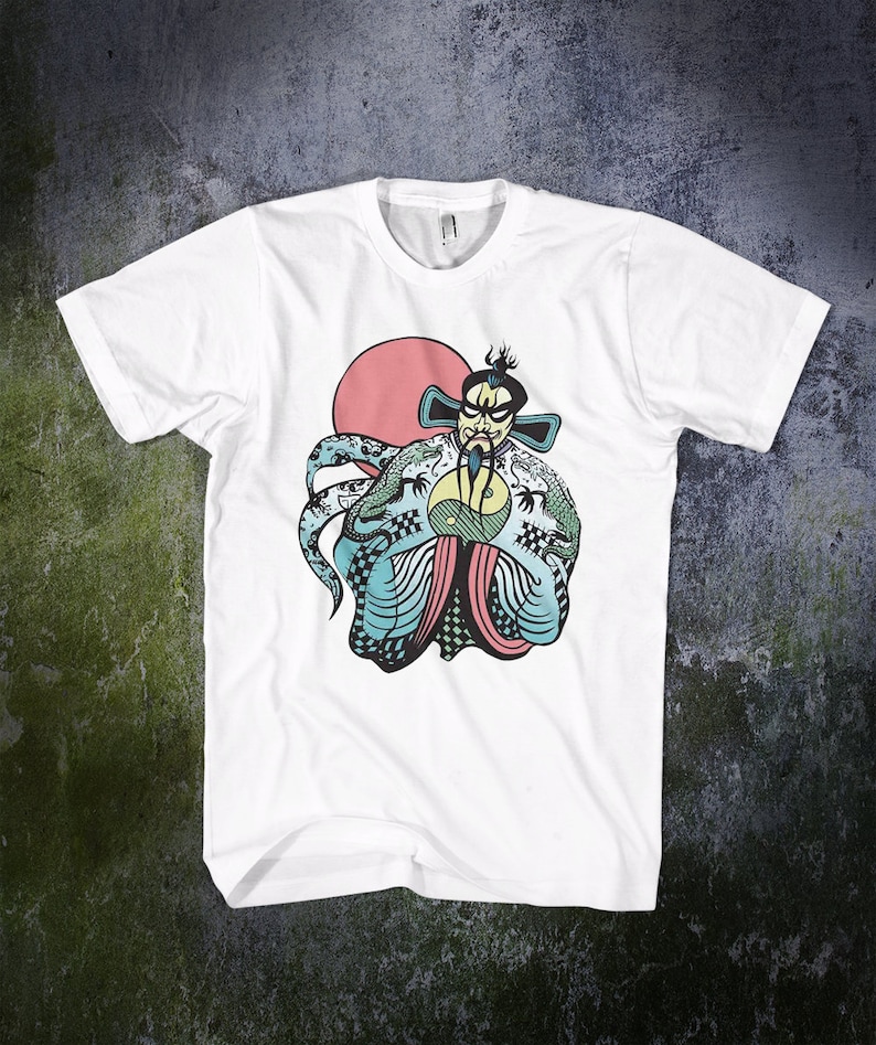 May include: A white short-sleeve t-shirt featuring a graphic illustration of a stylized figure with a beard and traditional headwear, wearing a robe with dragon motifs and a yin-yang symbol, set against a large solid red circle.
