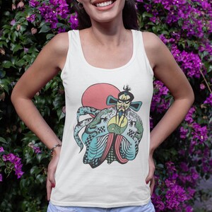 May include: A white tank top featuring a graphic print of a stylized figure with a beard and traditional robes, holding a yin-yang symbol in front of a large red circle. The design includes intricate blue and green dragon patterns.