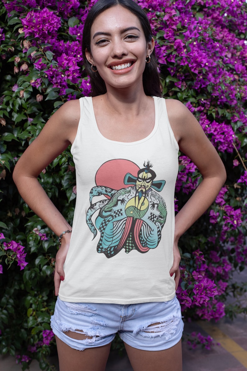 May include: A white tank top featuring a graphic print of a stylized figure with a beard and traditional robes, holding a yin-yang symbol in front of a large red circle. The design includes intricate blue and green dragon patterns.