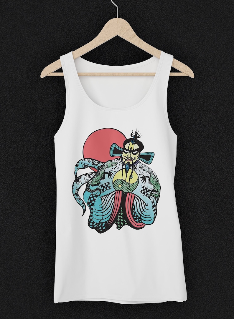 May include: A white tank top featuring a graphic illustration of a stylized figure with a beard and traditional headwear, flanked by green dragons, a yellow yin-yang symbol, and a large red circle against a light blue patterned background.