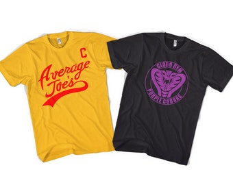 May include: A yellow t-shirt with red text reading Average Joe's and a red letter C, alongside a black t-shirt featuring a purple circular logo with a cobra graphic and the text Globo Gym Purple Cobras. Both shirts have short sleeves and crew necks.