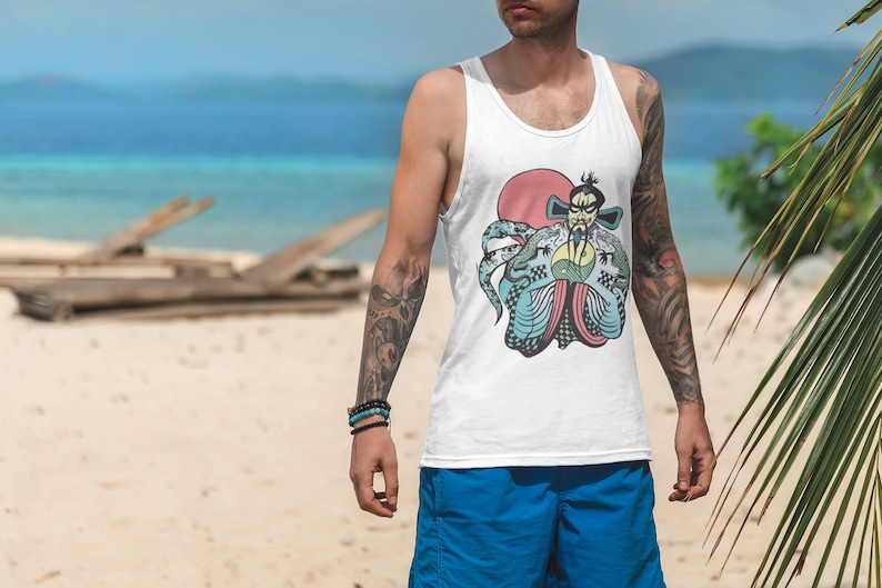 May include: A white tank top featuring a graphic print of a stylized figure with a beard, wearing traditional robes, positioned in front of a large red circle. The figure holds a yellow and green yin-yang symbol, surrounded by blue and green dragon-like creatures.