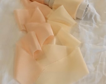 Hand dyed raw edged duo of silk ribbon in shades of peachy blush and cream each roll approx 2”x3m