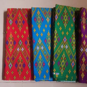 May include: Four fabric swatches with a geometric pattern in red, blue, green, and purple.