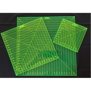 May include: Three neon green quilting rulers of varying sizes. Each ruler has grid lines and angle markings in inches, with measurements up to 12 inches. The rulers are made of transparent acrylic and are designed for precise fabric cutting and quilting.