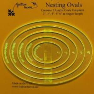 May include: Clear acrylic nesting oval templates. The set includes five templates, ranging from 2" to 6" at their longest length. The text "Nesting Ovals" and "Quilters Haven" are printed on the templates. The background is a warm, golden color.