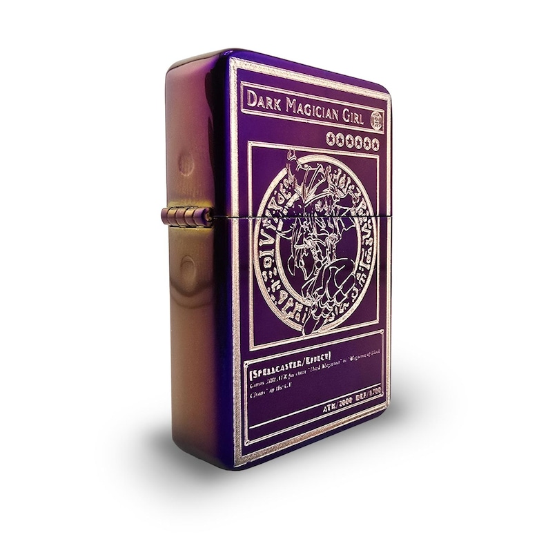 May include: A purple metal lighter with an engraved image of a Dark Magician Girl card from the Yu-Gi-Oh! Trading Card Game. The card text reads "DARK MAGICIAN GIRL", "000000", "[SPELLCASTER/Effect]", "ATK/2000 DEF/1700".