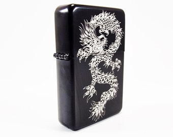 May include: Black lighter with a white dragon design.