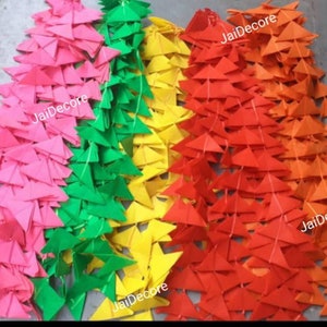 May include: A set of four colorful paper garland strands, each strand is made of triangular paper flags. The colors are pink, green, yellow, and orange. The garland strands are strung together with a thin string. The image includes the text "JaiDecor" on three of the strands.