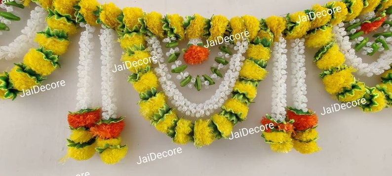 May include: A yellow and white floral garland with green accents. The garland is made of artificial flowers and is perfect for decorating for a special occasion.