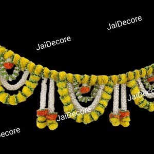 May include: A yellow and green garland made of artificial flowers, with white strings hanging down. The garland is decorated with small orange flowers.