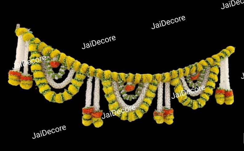 May include: A yellow and green garland made of artificial flowers, with white strings hanging down. The garland is decorated with small orange flowers.