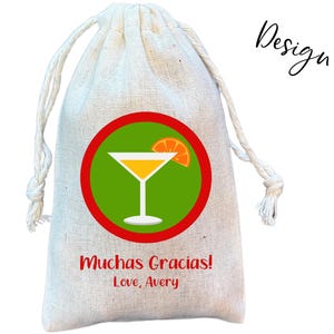 May include: A white burlap gift bag with a red circle containing a green background and a yellow cocktail with a lime wedge. The text "Muchas Gracias! Love, Avery" is printed below the circle.