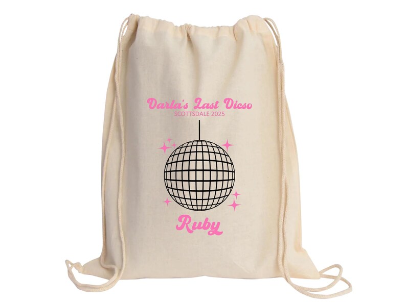 May include: A white drawstring bag with a pink and black design. The bag features a disco ball, stars, and the text "Darla's Last Disco Scottsdale 2023" and "Ruby".