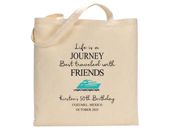 May include: Cream-colored tote bag with the text "Life is a JOURNEY Best traveled with FRIENDS" and a turquoise cruise ship graphic. Below, it reads "Kirsten's 50th Birthday COZUMEL, MEXICO OCTOBER 2025". The bag has a handle.