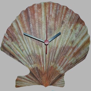 May include: A decorative wall clock shaped like a scallop shell, featuring a painted design in beige, brown, and red hues. The clock has black hands and a red second hand. The clock's design mimics the natural texture of a seashell.