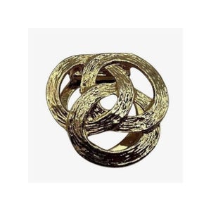 May include: A gold-toned metal brooch featuring three interlocking circular rings. The surface of the metal has a textured, hammered finish that creates a light-reflecting appearance across the curved, overlapping loops of the circular design.