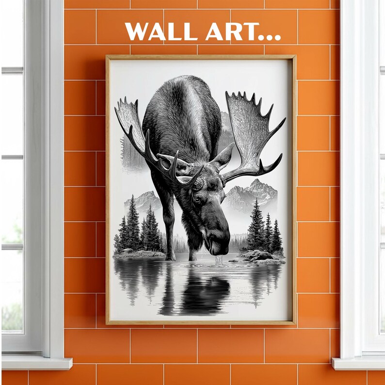 May include: Framed black and white wall art featuring a moose drinking from a lake, with mountains and trees in the background. The artwork is displayed on an orange tiled wall, with the text "WALL ART..." at the top.