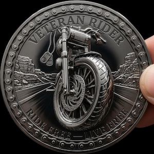 May include: A circular silver-toned commemorative coin featuring a motorcycle front end, dog tags, and a desert road landscape. The text VETERAN RIDER is at the top, and RIDE FREE - LIVE FREE is at the bottom. A motorcycle chain border surrounds the design.