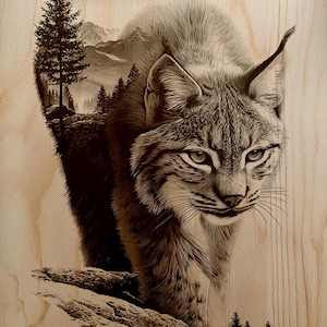 May include: A detailed wood-burned image of a bobcat, with a mountain and forest scene subtly incorporated into its form. The artwork is rendered in shades of brown and gray, creating a textured, naturalistic effect.