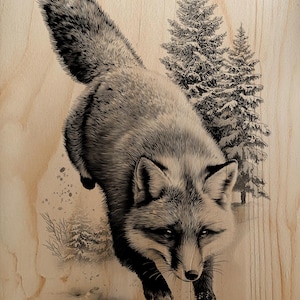 May include: A detailed monochrome illustration of a fox in mid-leap, with pine trees and a snowy scene in the background. The artwork is presented on a light-toned wooden surface.