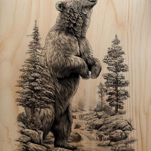 May include: A detailed black and white illustration of a bear standing upright, roaring, and set against a backdrop of a forest scene. The artwork is on a light-colored wooden surface, with trees and a waterfall adding depth.