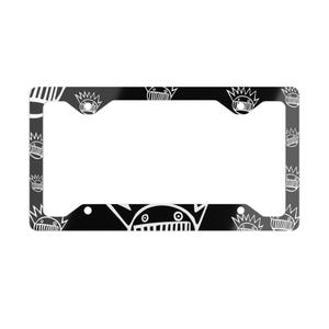May include: Black license plate frame with a repeating white cartoon face design. The frame has a rectangular shape with rounded corners and a large open space for the license plate. The design includes a crown and a face.