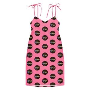 May include: A bright pink sleeveless dress featuring thin tie-shoulder straps and a repeating pattern of black circular motifs. Each circle contains a swirling, multi-colored graphic design with a central rainbow-colored text element.