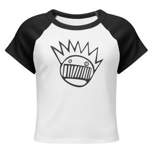 May include: White crop top with black raglan sleeves featuring a black and white graphic of a face with spiky hair. The shirt has a crew neck and is made of a soft material.