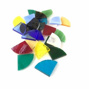 May include: Assortment of colorful glass mosaic tiles in various shapes and sizes. The tiles are in shades of red, yellow, green, blue, and white.
