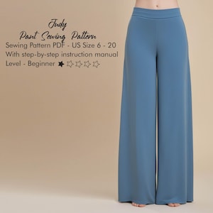 Pode incluir: Calças azuis claras de perna larga. A imagem inclui o texto "Judy Pant Sewing Pattern" e detalhes sobre o padrão, incluindo tamanhos 6-20, formato PDF e nível iniciante. As calças são feitas de um tecido liso.