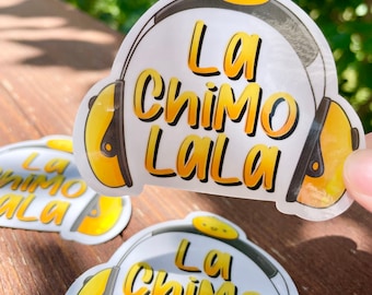 May include: Clear stickers featuring a yellow and black headset design with the text "La Chimo Lala" in yellow. A small yellow cartoon chick is at the top of the headset. Several stickers are visible.