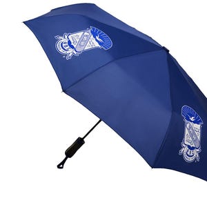May include: A navy blue umbrella with a white and blue emblem on the canopy. The emblem features a crest design with text. The umbrella is partially open, showing its black handle and frame.