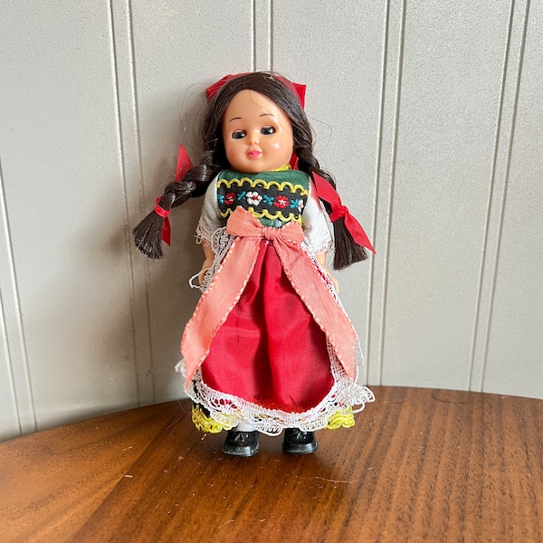 Vtg INTERNATIONAL FOLK DOLL 5" Girl, Blue Sleepy Eyes, Brown Braids, Embroidered Yoke, Red Apron & Scarf, Hard Plastic, Nationality Doll